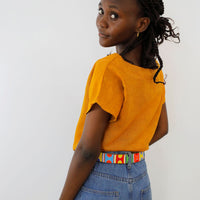 Back side of multi arrows beaded leather belt on model.