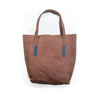 Brown tote bag with slate beaded accents on a white background