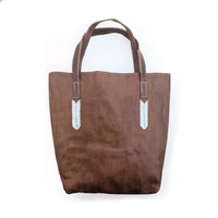 Brown tote bag with white beaded accents on a white background