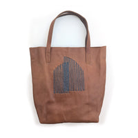 Brown leather tote bag with slate arc beading.