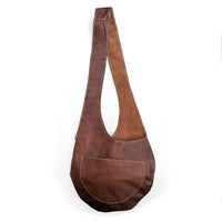 Brown leather sling bag on a white background