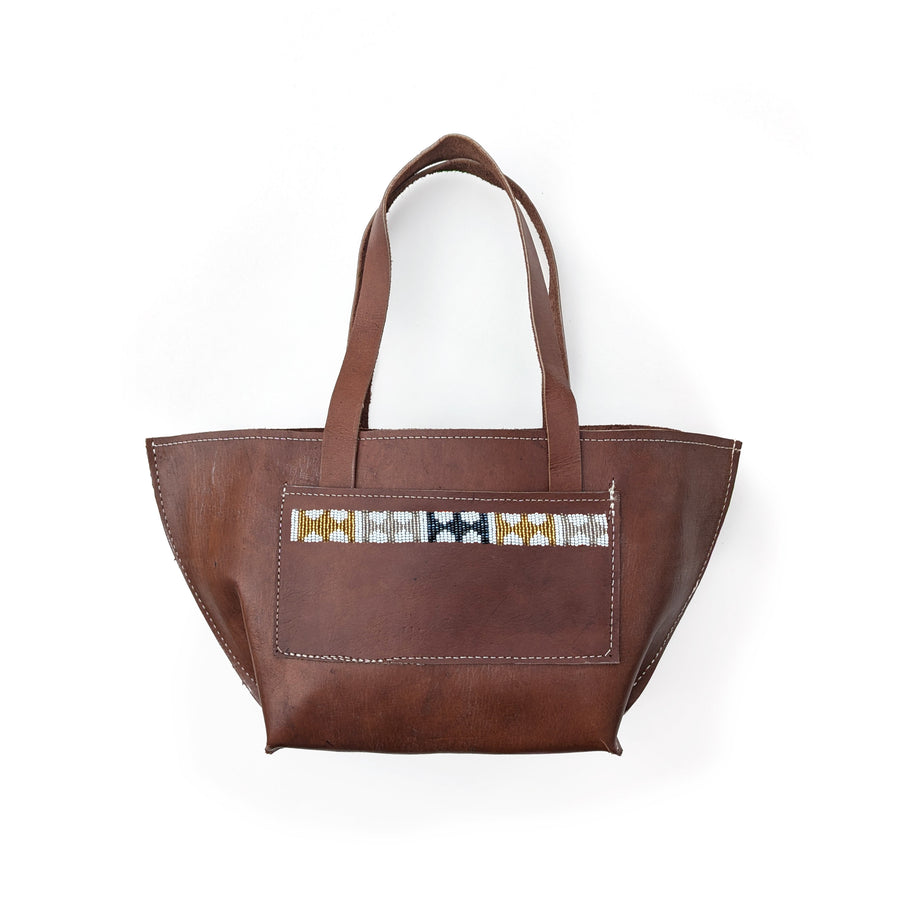 Brown leather shoulder bag with metallic geometric beaded accents on a white background.