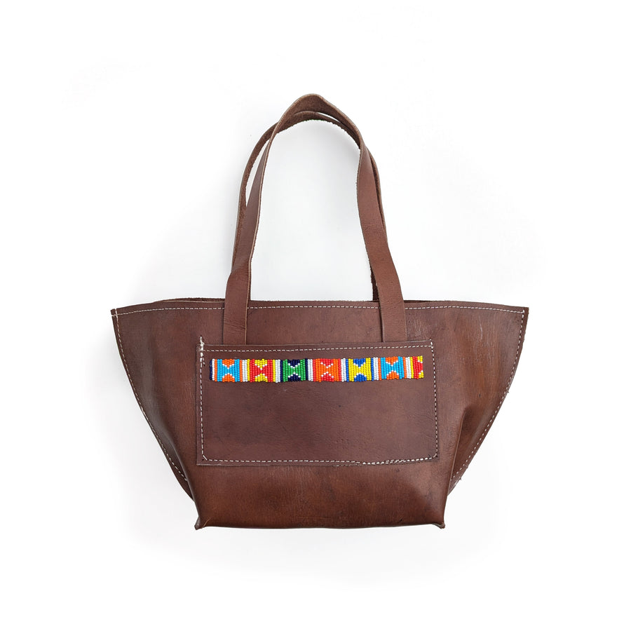 Brown leather shoulder bag with colorful geometric beaded accents on a white background.