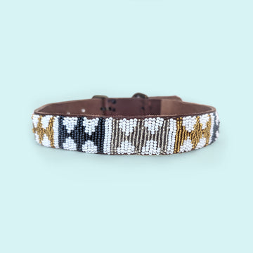 Arrows Metallic Beaded dog collar with brown leather strap on a light blue background