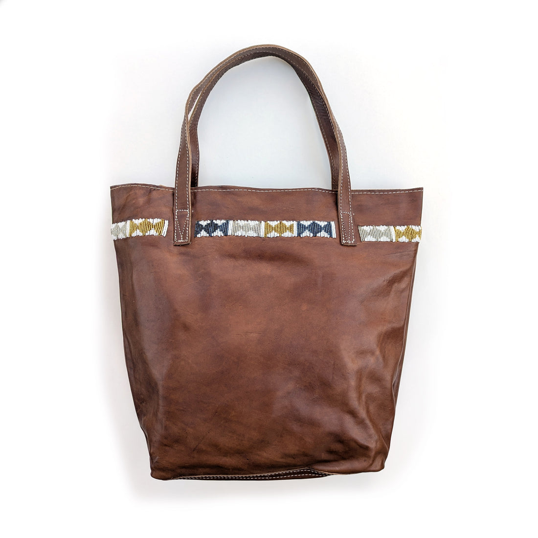 Leather tote bag with metallic geometric beaded design along the top.