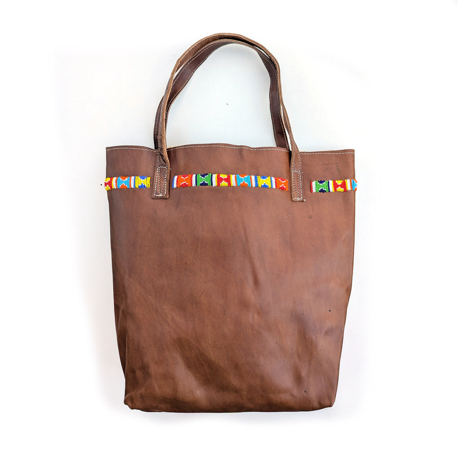 Leather tote bag with colorful geometric beaded design along the top.