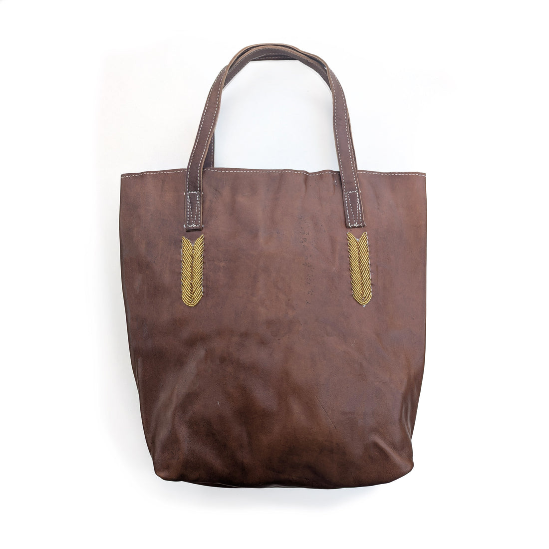 Brown tote bag with gold beaded accents on a white background