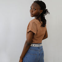Back side of black and white stitches belt on model.