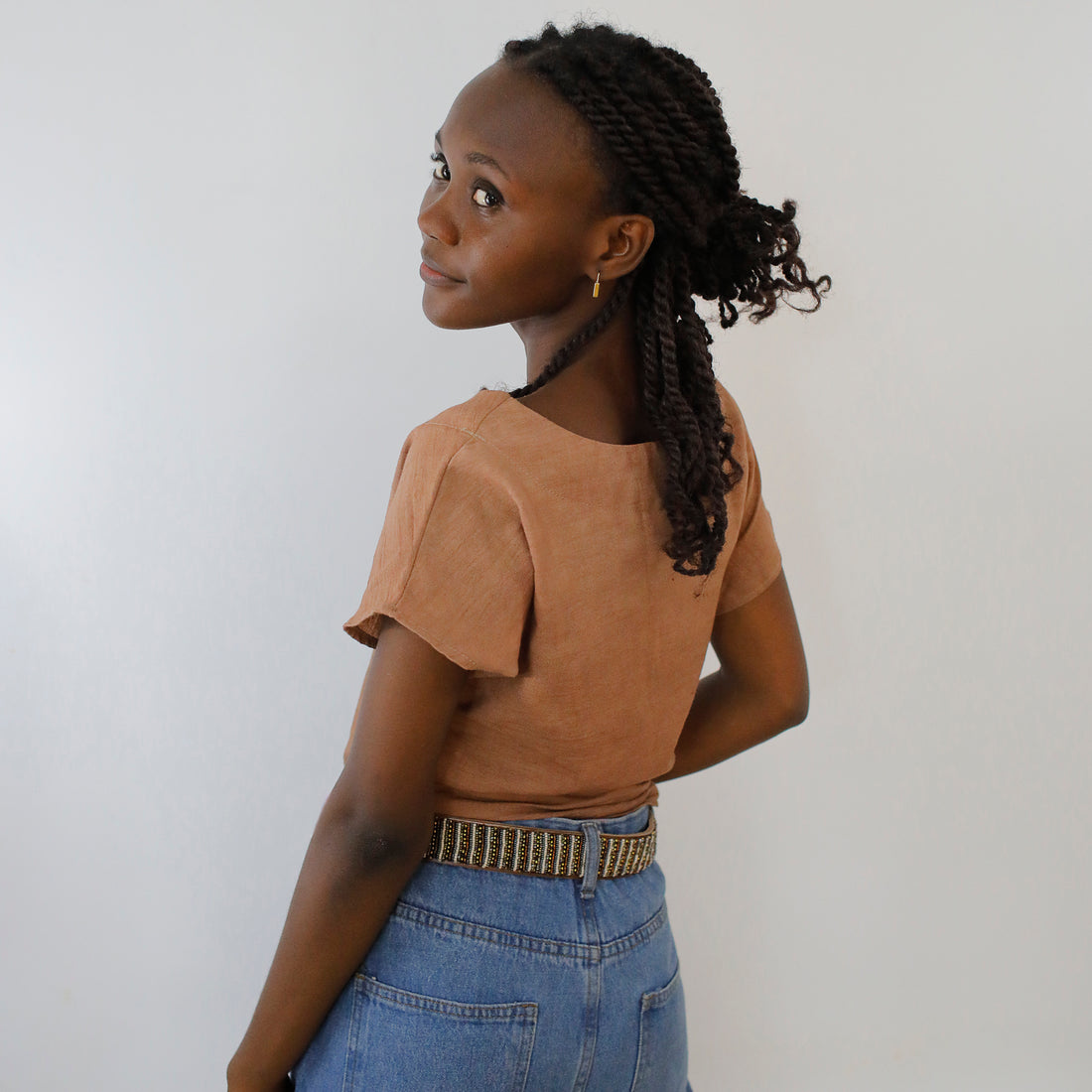 Back side of Stripes Neutral Beaded Leather Belt on model.