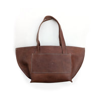 Brown leather shoulder bag on a white background