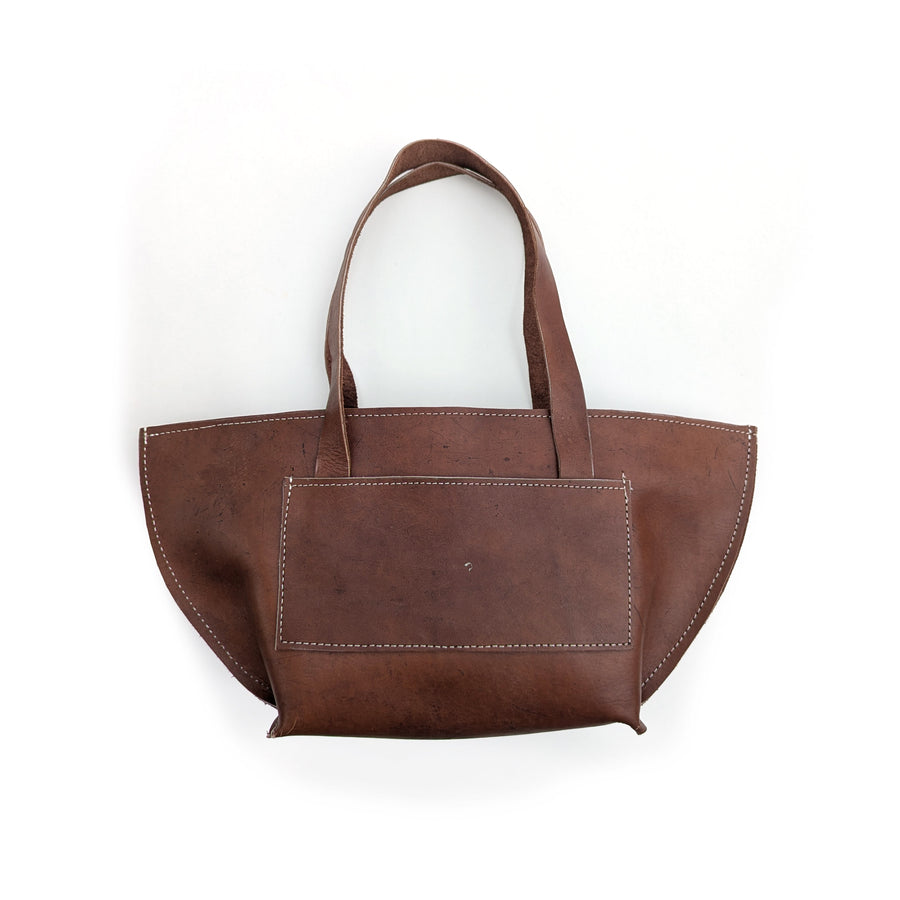 Brown leather shoulder bag on a white background