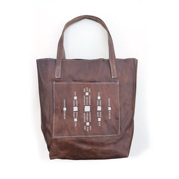 Leather tote bag with square front pocket and white geometric beaded design.